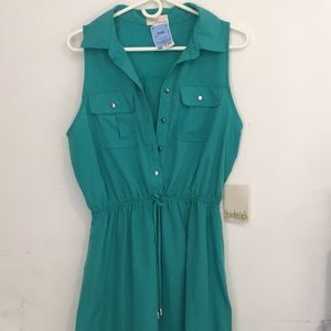 Turquoise blue dress with silver buttons.